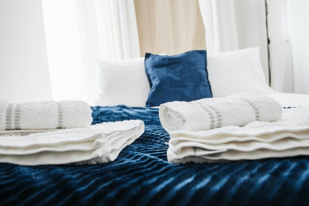 free photo of fresh towels on the bed in a hotel room